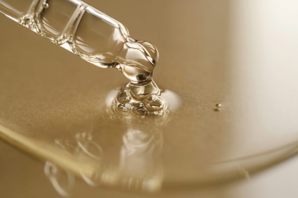 Pipettes with oil or serum on a golden background. A great photo for your cosmetic product.